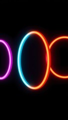 Colorful neon circles illuminated against a dark background creating a vibrant abstract display in a minimalist style