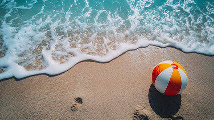 Obraz premium A beach ball on a sandy beach with waves.