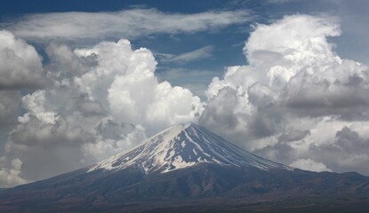 Mount Fuji in the daytime with white clouds as a background.