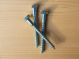 Galvanized hex steel lag bolts. Lag bolts and wood screws. Structural elements of wooden buildings...