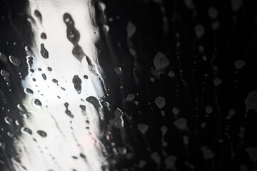 Soap sud wave pattern on car windshield. During an automatic wash cycle.