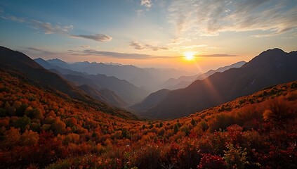 Obraz premium A majestic autumn sunset in the mountains, casting a golden glow over the landscape.