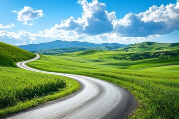 Fototapeta premium Winding Road Through Rolling Green Hills Under Blue Sky