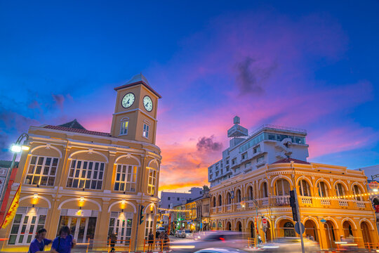 Pink cloud in blue sky above The classic building in Phuket old town. Scene of romantic beautiful sky sunset with slow moving cloud in the sky background. The clock tower is a landmark of Phuket.
