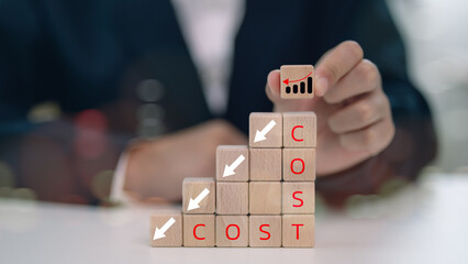 Cost reduction concept. Businessmen put wooden cubes with the words cost and green down arrows. graph with cost reduction business finance. Business, technology, cost management, cut budget.