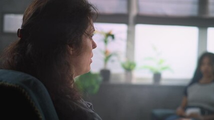 Close up of female psychologist talking with teenager, providing psychotherapy or treatment for African American teenage girl on counseling session. Psychological assistance and advice. Slow Motion.