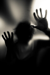 Scary picture of hands behind glass, horror ghost behind door, Halloween concept