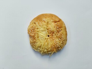 Round shaped bread with sesame topping and grated cheese topped with chocolate filling. on a white background