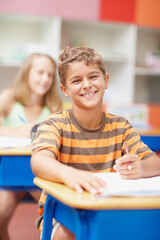 School, books and portrait of child in classroom for learning, education and lesson for...