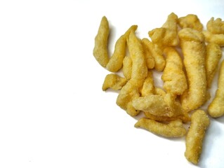 yellow crunchy corn chips with a sweet and savory taste on a white background.