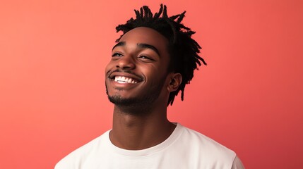 Fototapeta premium A young man with dreadlocks smiles broadly.