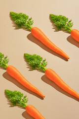 Carrots arranged in a diagonal pattern on beige backdrop. Perfect for food blogs, healthy eating promotion, and farmfresh produce concepts.