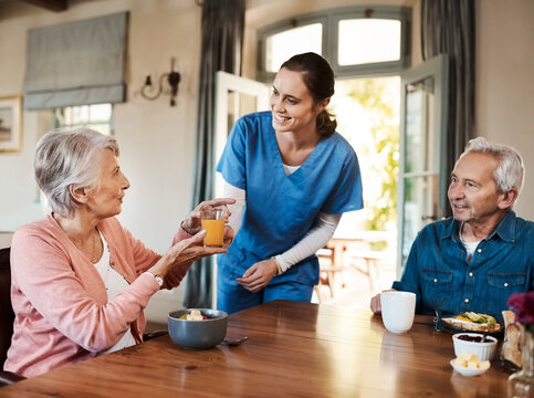 Juice, helping and nurse with senior couple in assisted living facility with healthy breakfast for nutrition. Happy, talking and caregiver with elderly patients for fruit drink in retirement home.