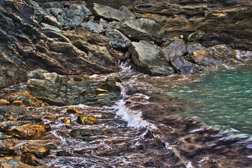Rocky Shoreline with Gentle Waves in Tintagel, Cornwall, UK