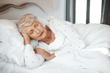 Senior woman, sleeping and tired in bed to dream, morning fatigue and lazy in retirement home....