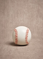 Well-worn baseball resting on a textured background