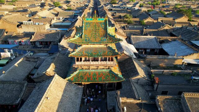 Famous Chinese pagoda in Pingyao ancient town at sunset. Aerial 4K