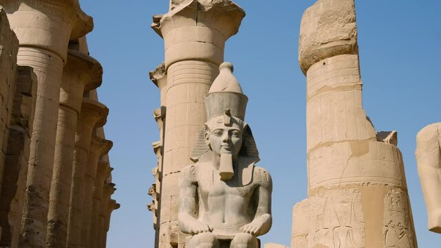 Huge Granite Statue Of Ramesses II Seated At The Front Of Columns In Luxor Temple, Egypt. Low Parallax Angle