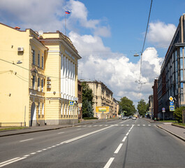 A street with a yellow building and a white building