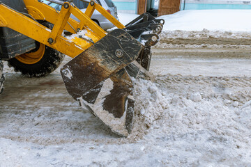 A snow plow is clearing a road of snow