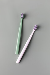 Toothbrushes with soft bristle and mockup handles on grey