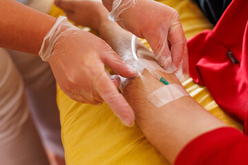 Healthcare Professional Inserting IV in Patient's Arm