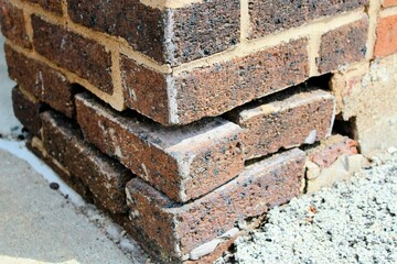 crumbling corner of old brick building