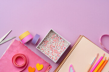 Crafting supplies on a purple background ready for creative projects