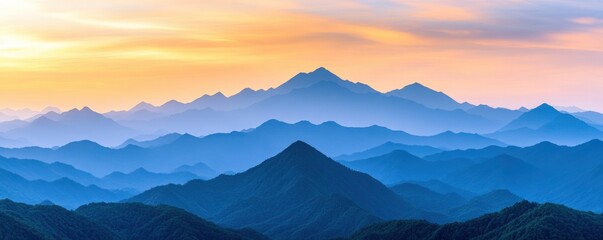 Obraz premium A serene mountain landscape with layered peaks fading into the distance under a colorful sunset sky.