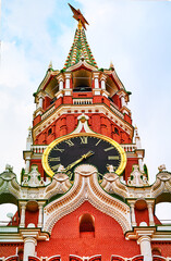 Fototapeta premium The main clock of the Moscow Kremlin, Kuranti, on Red Square, Spasskaya Tower. View from below. On light blue background. Close-up. 