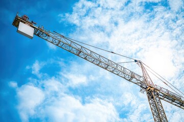 large white sign is suspended from a crane
