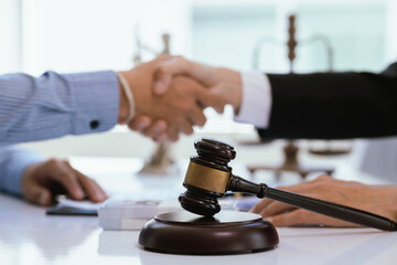 A professional lawyer advises a client in a corporate office, discussing legal documents, contracts, and finance. They consult on justice, legislation, and agreements during an important legal meeting