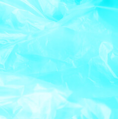 Obraz premium Summer background plastic blue wrinkle bag film glossy crumpled overlay package rough wrap material pack reflection texture floor packaging retail grain pollution trash polyethylene.