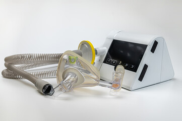 Continuous positive airway pressure system includes of CPAP machine, mask, tube on white background.