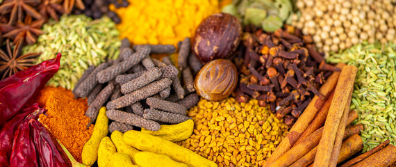 Various spices, peppers and herbs close-up top view. Eastern spice market. A set of peppers and spices for cooking.
