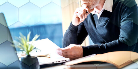 Senior businessman reading a document, geometric pattern