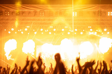 Crowd at concert and colorful stage lights.