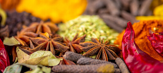 Various spices, peppers and herbs close-up top view. Eastern spice market. A set of peppers and spices for cooking.