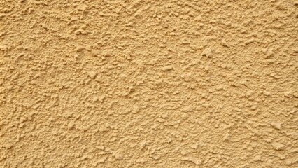 A detailed look at a brown stucco wall's rugged surface, revealing minute cracks and irregularities that add depth