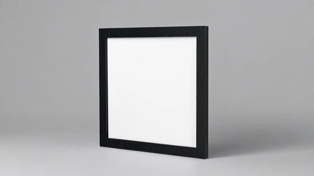 A sleek black picture frame with a textured finish stands against a gray background. Its modern design invites customization with photos or artwork, perfect for various settings.