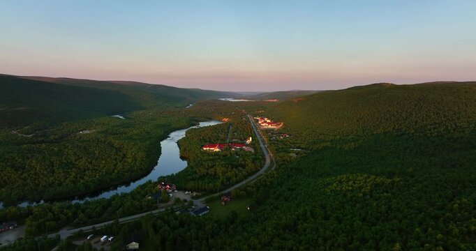 Aerial view following the Stuorraluoppal river, summer evening in Utsjoki, Finland