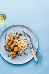 Pearl Barley Porridge or Italian Orzotto with porcini mushrooms, baked pumpkin and thyme, aromatic herbs. Autumn and winter healthy Orzotto, whole grain, barley provides fiber, vitamins, minerals