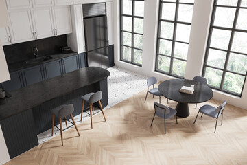 Top view of home kitchen interior with island, cabinet and table near window