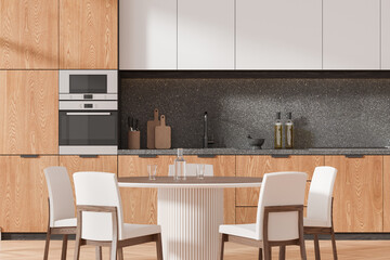 Wooden home kitchen interior with dining table and cooking space, closeup