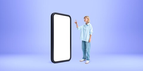 A person wearing casual clothes points at a giant blank smartpho