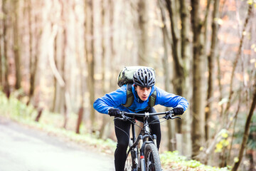 Fototapeta premium Active man on bike in the middle of beautiful nature, early autumn morning. Concept of healthy lifestyle.