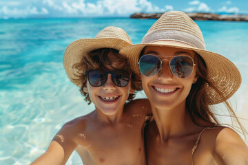 Mother and son taking selfie on beach vacation