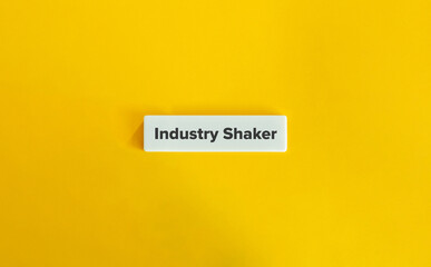 Industry Shaker Expression. Text on Block Letter Tile on Yellow Background. Minimal Aesthetic.