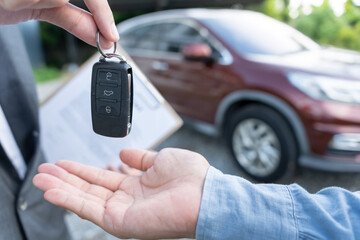 lease, rental car, sell, buy. Dealership manager send car keys to the new owner.  Sales, loan credit financial, rent vehicle, insurance,  renting, Seller, dealer, installment, car care business