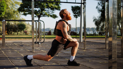 Profile view of sportsman training in park in morning 